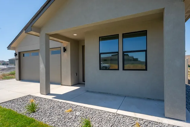 a view of a hallway with wooden floor and a living room