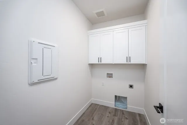 a view of room with wooden floor and cabinet