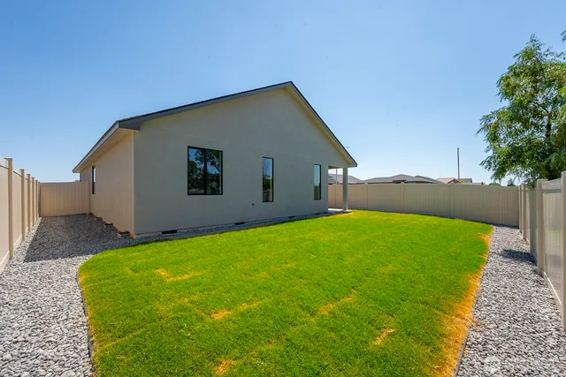 a backyard of a house with lots of green space