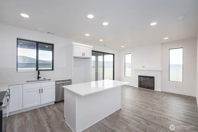 a large white kitchen with a large window