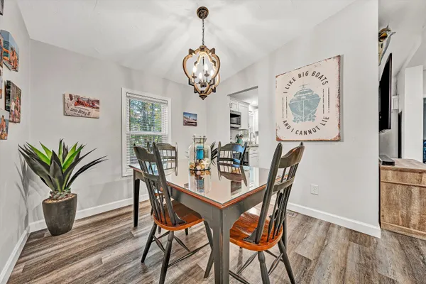 a dining room with furniture and wooden floor