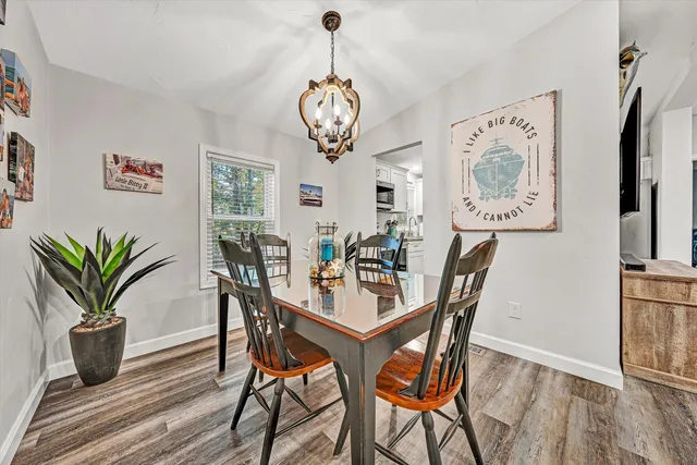 a dining room with furniture and wooden floor