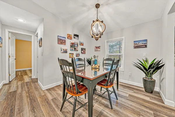 a view of a dining room with furniture wooden floor and chandelier