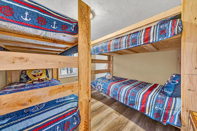 a room with a bed and a book shelf