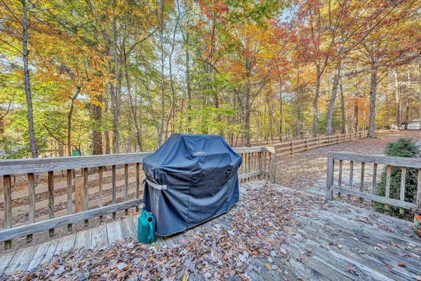 a view of a roof deck with wooden floor and fence