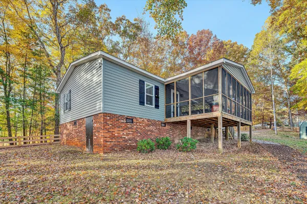 a front view of a house with a yard and potted plants