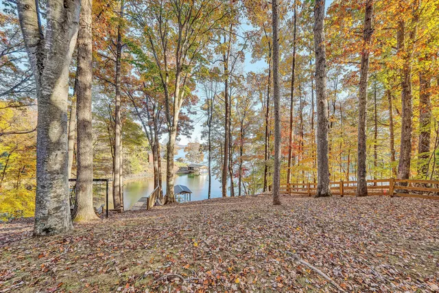 a view of a house with a patio and a backyard