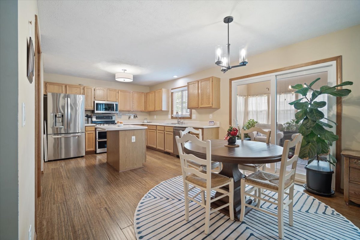 1024 Kings Mill Road Normal, IL 61761 - Photo 4 of 21 a kitchen with stainless steel appliances a dining table chairs stove refrigerator and cabinets