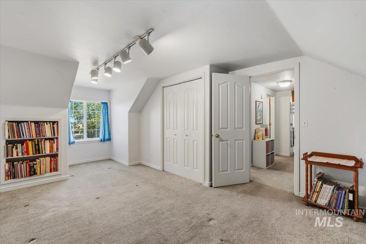 2331 Gulley Road Homedale, ID 83628 - Photo 25 of 46 Carpeted room with a built-in bookshelf, a double-panel window, track lighting, and a closet with bifold doors