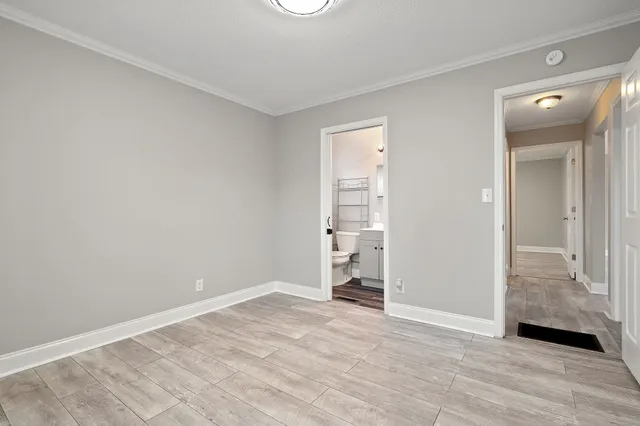 a bathroom with a sink a mirror a glass door and shower
