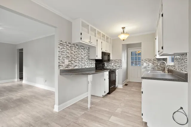 a kitchen with stainless steel appliances a stove sink and cabinets