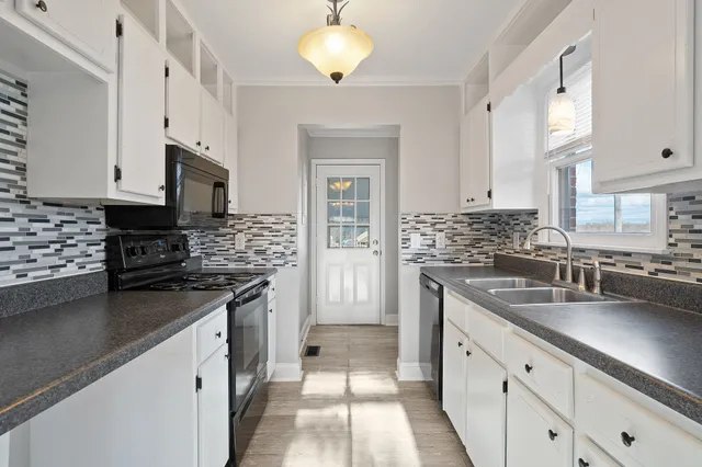 a kitchen that has a sink and a stove
