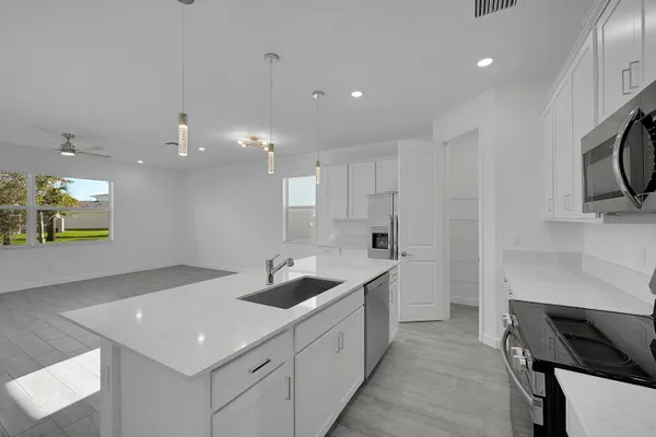 a kitchen with a sink stainless steel appliances and cabinets