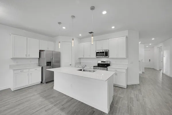 a kitchen with refrigerator and cabinets