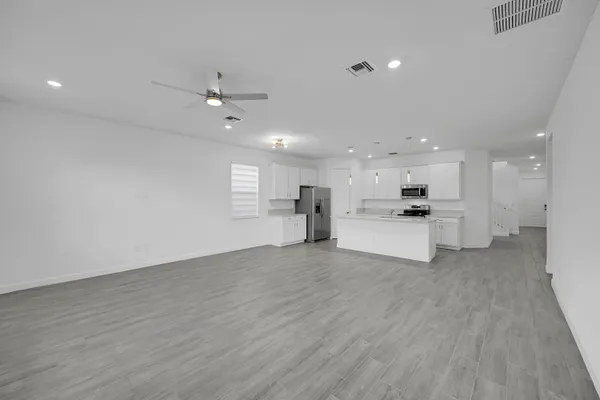 a view of kitchen with wooden floor and windows