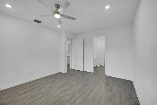 a view of empty room with wooden floor
