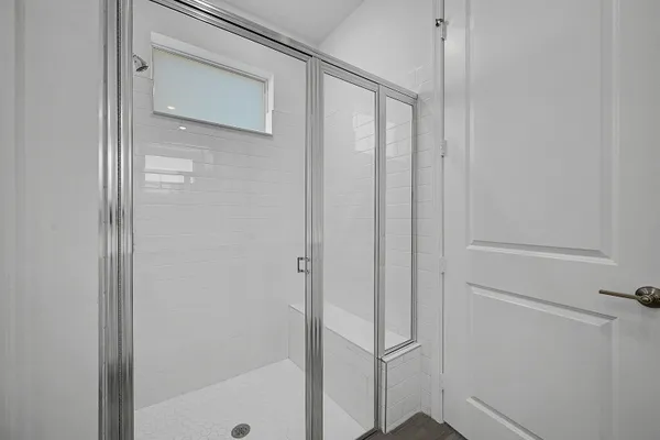 a bathroom with a glass shower door