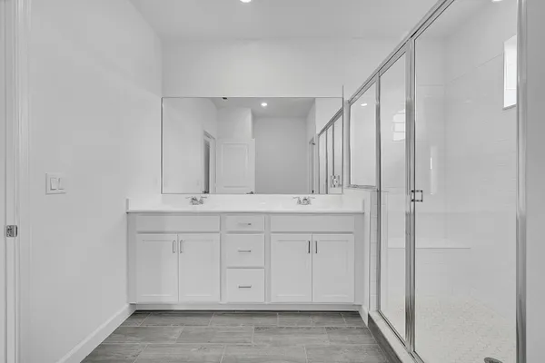 a bathroom with a double vanity sink and a mirror