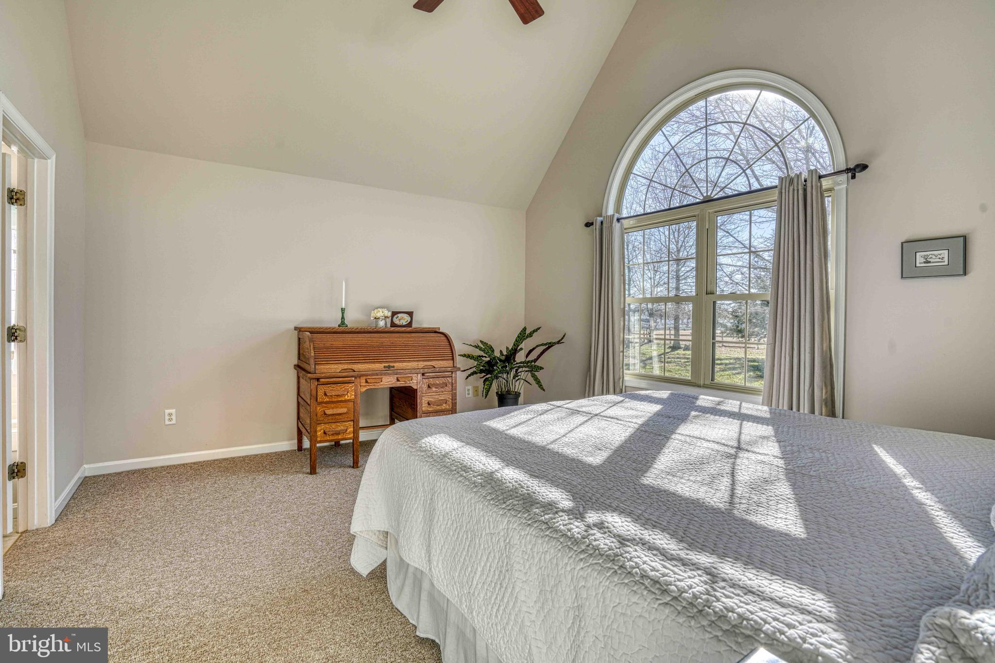 36620 Robin Hood Road Delmar, DE 19940 - Photo 17 of 48 a bedroom with a bed and a chandelier