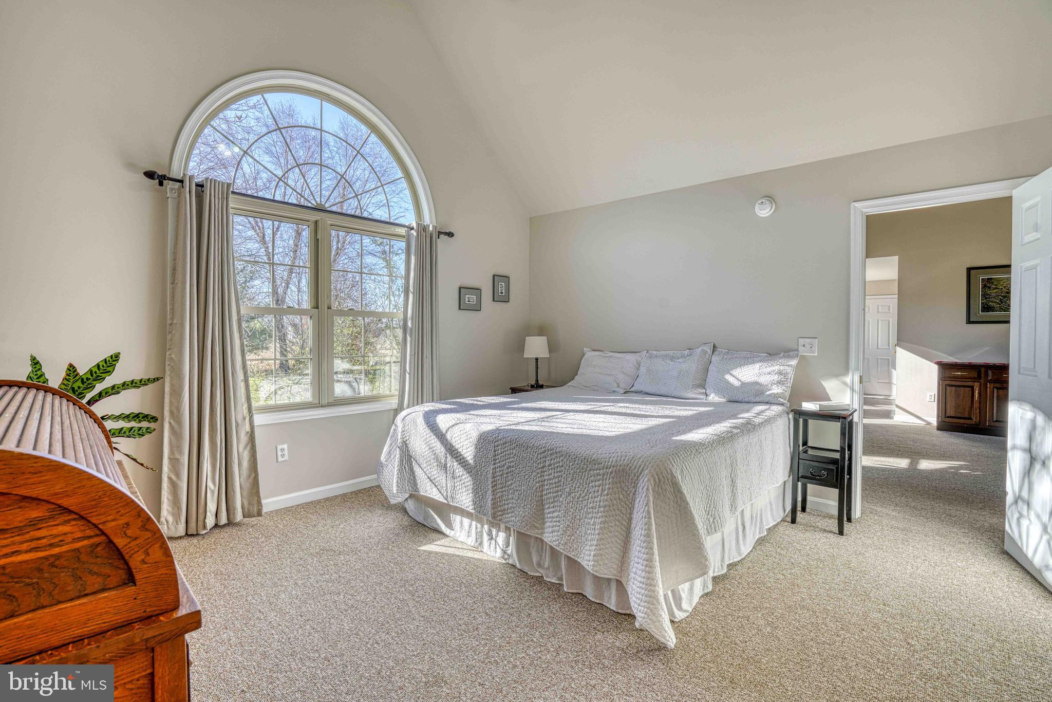 36620 Robin Hood Road Delmar, DE 19940 - Photo 18 of 48 a spacious bedroom with a bed a table and a large mirror