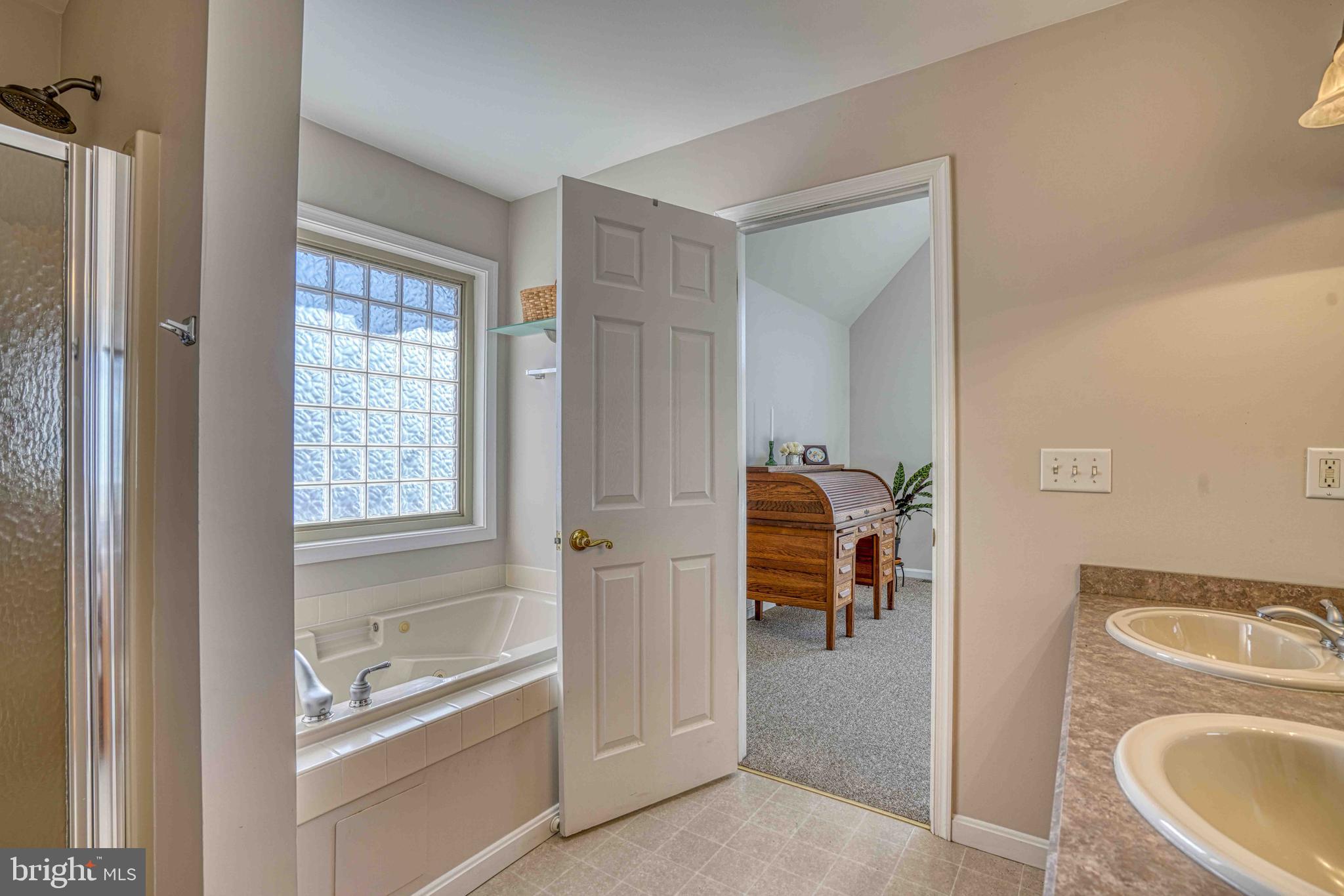 36620 Robin Hood Road Delmar, DE 19940 - Photo 21 of 48 a view of a bathroom with washing machine and a bath tub