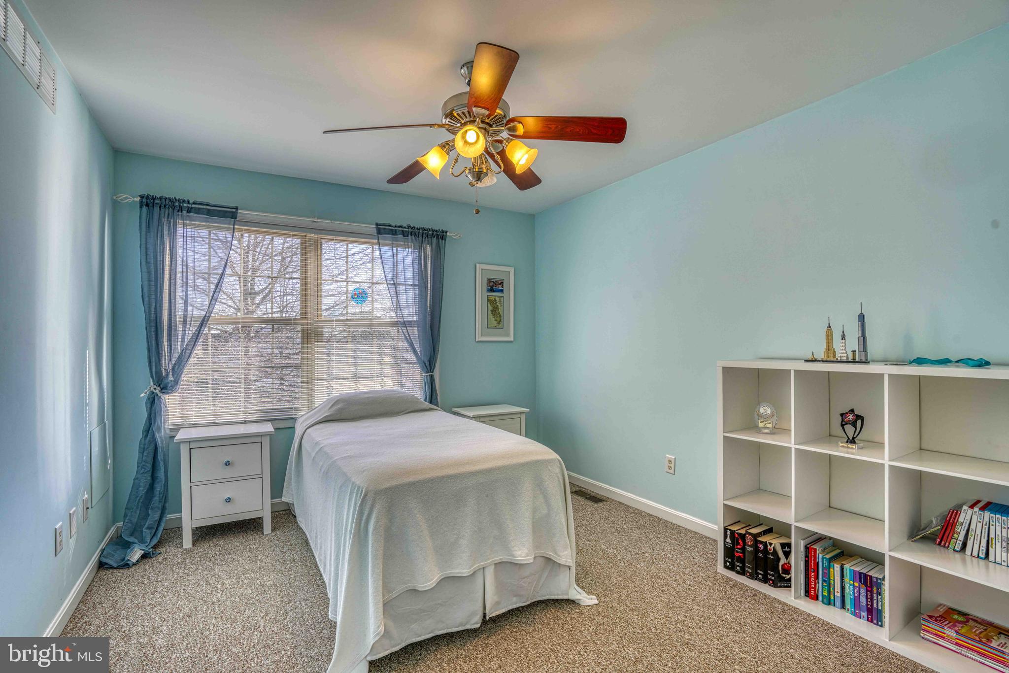 36620 Robin Hood Road Delmar, DE 19940 - Photo 22 of 48 a bedroom with a bed and a chandelier