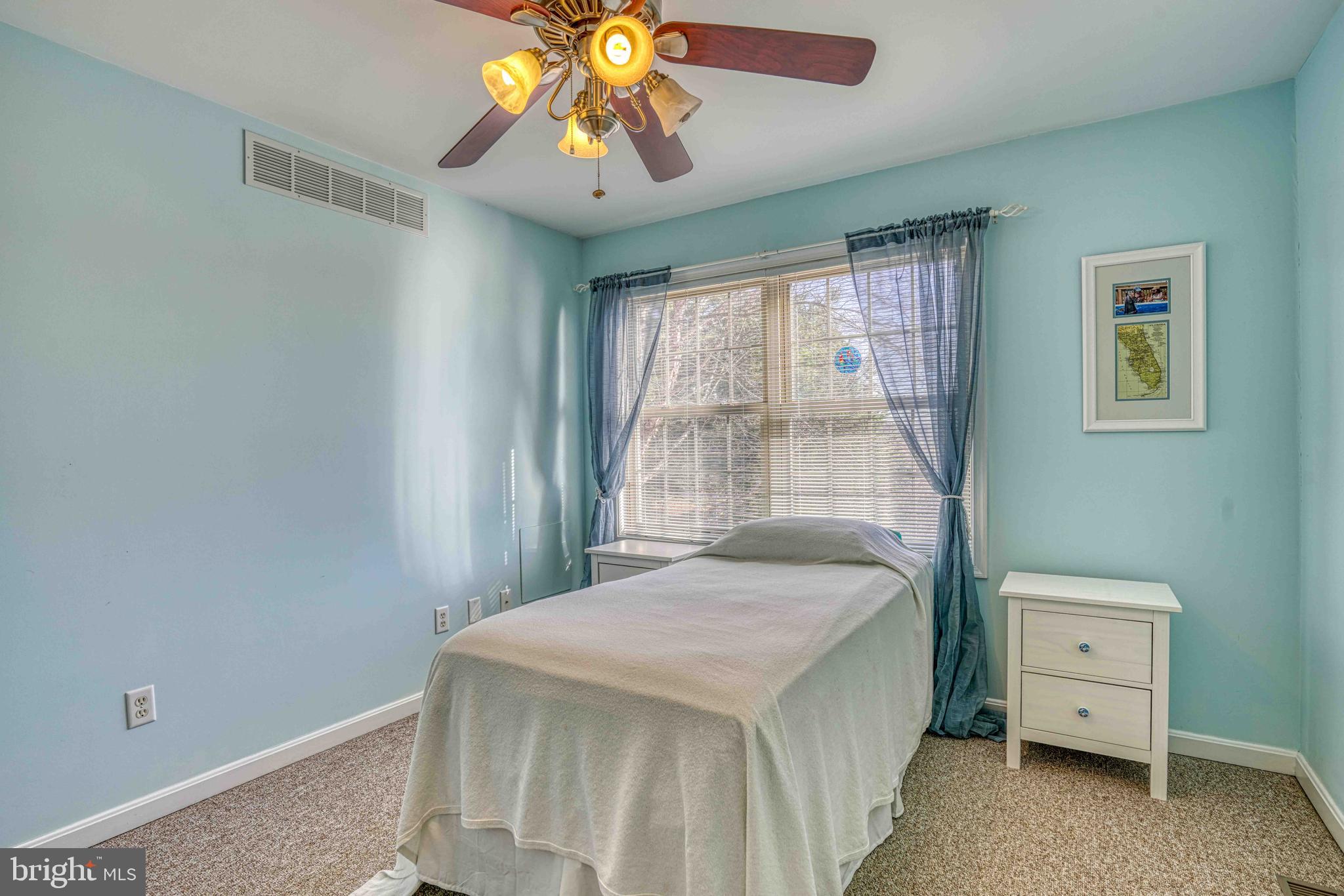 36620 Robin Hood Road Delmar, DE 19940 - Photo 23 of 48 a bedroom with a bed and a chandelier