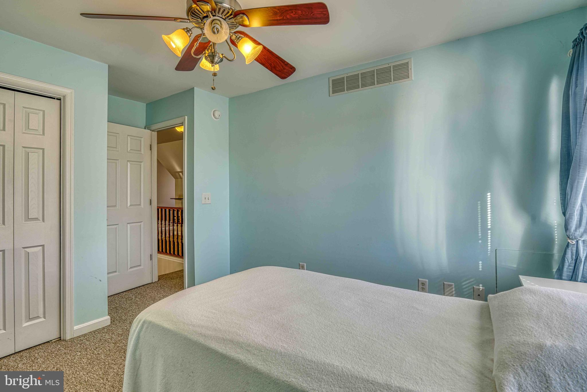 36620 Robin Hood Road Delmar, DE 19940 - Photo 24 of 48 a bedroom with a bed and a chandelier
