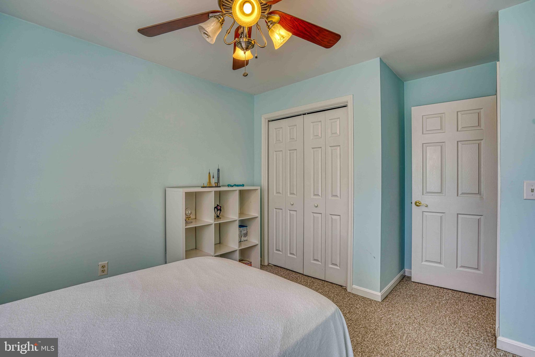 36620 Robin Hood Road Delmar, DE 19940 - Photo 25 of 48 a bedroom with a bed and a chandelier fan