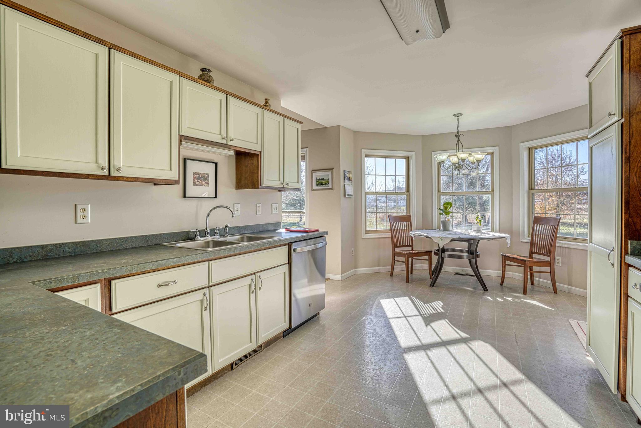 36620 Robin Hood Road Delmar, DE 19940 - Photo 10 of 48 a kitchen with granite countertop sink cabinets and dining table