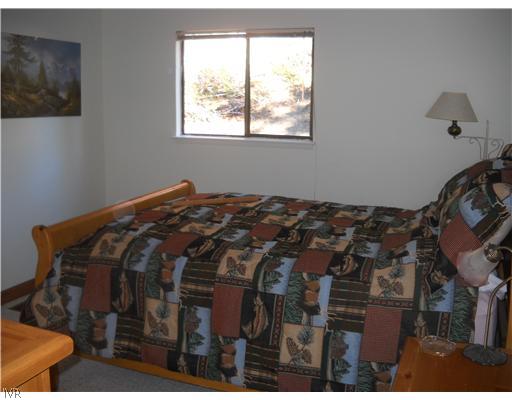 1329 Thurgau Court Incline Village, NV 89451 - Photo 7 of 11 a bed sitting in a bedroom next to a window