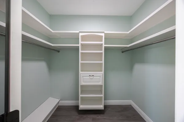 a view of walk in closet with empty racks
