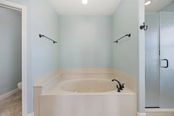 a white bath tub sitting next to a white sink