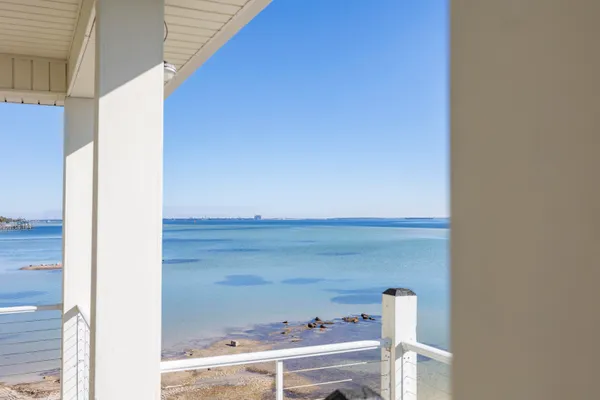 an aerial view of a house with outdoor space and ocean view