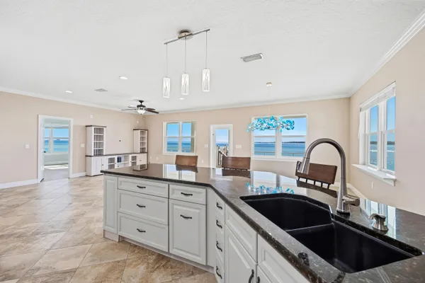 a kitchen with granite countertop a sink stainless steel appliances and cabinets