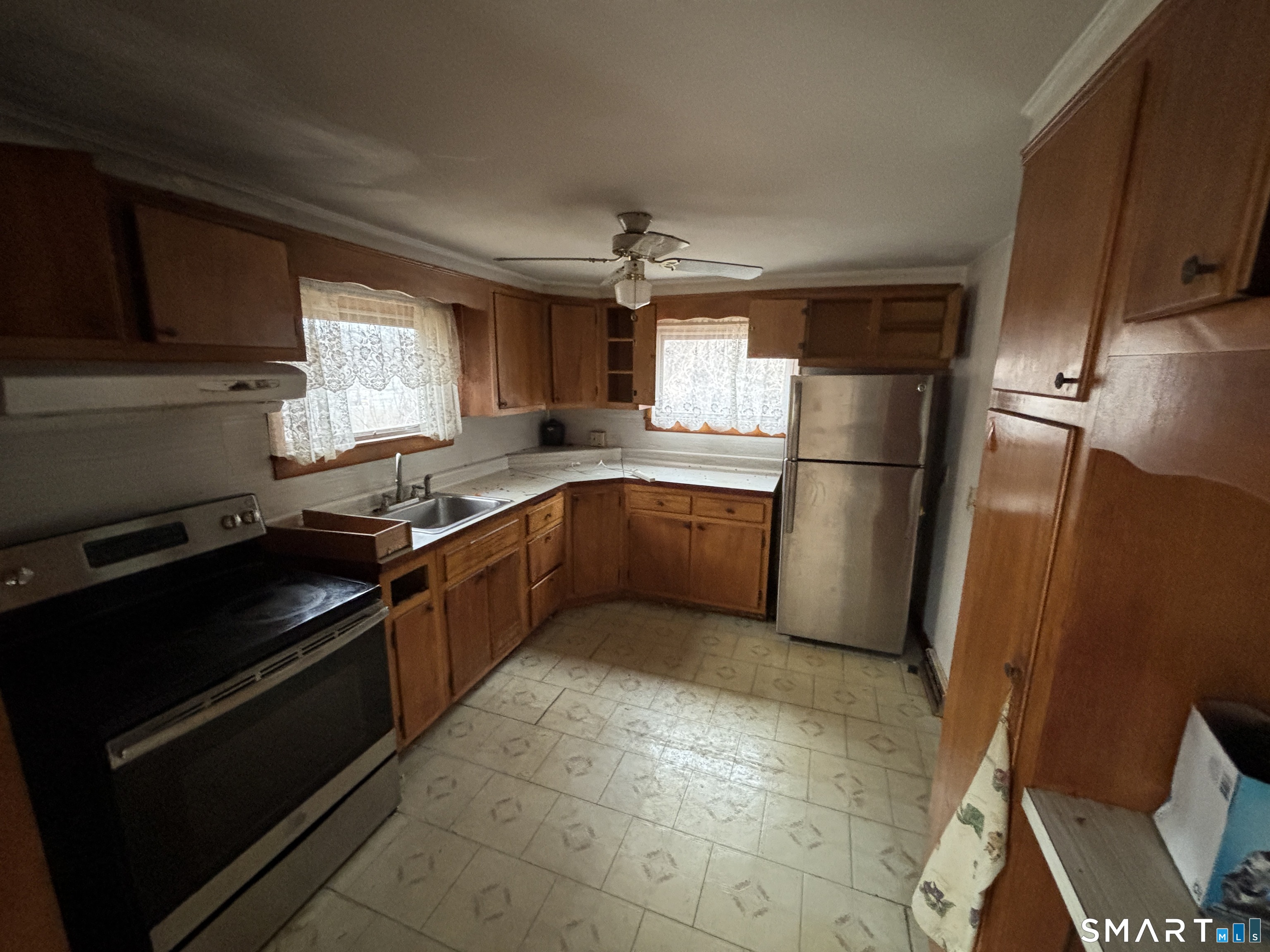 44 Upper State Street North Haven, CT 06473 - Photo 7 of 11 a kitchen with a refrigerator sink and wooden cabinets