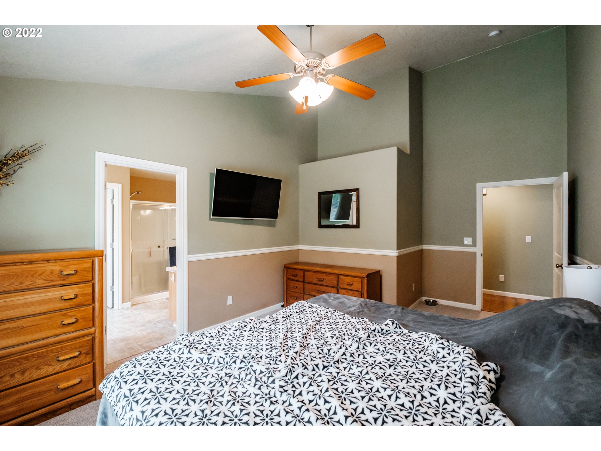 3778 10th Street Hubbard, OR 97032 - Photo 17 of 32 a bedroom with a bed and a flat screen tv