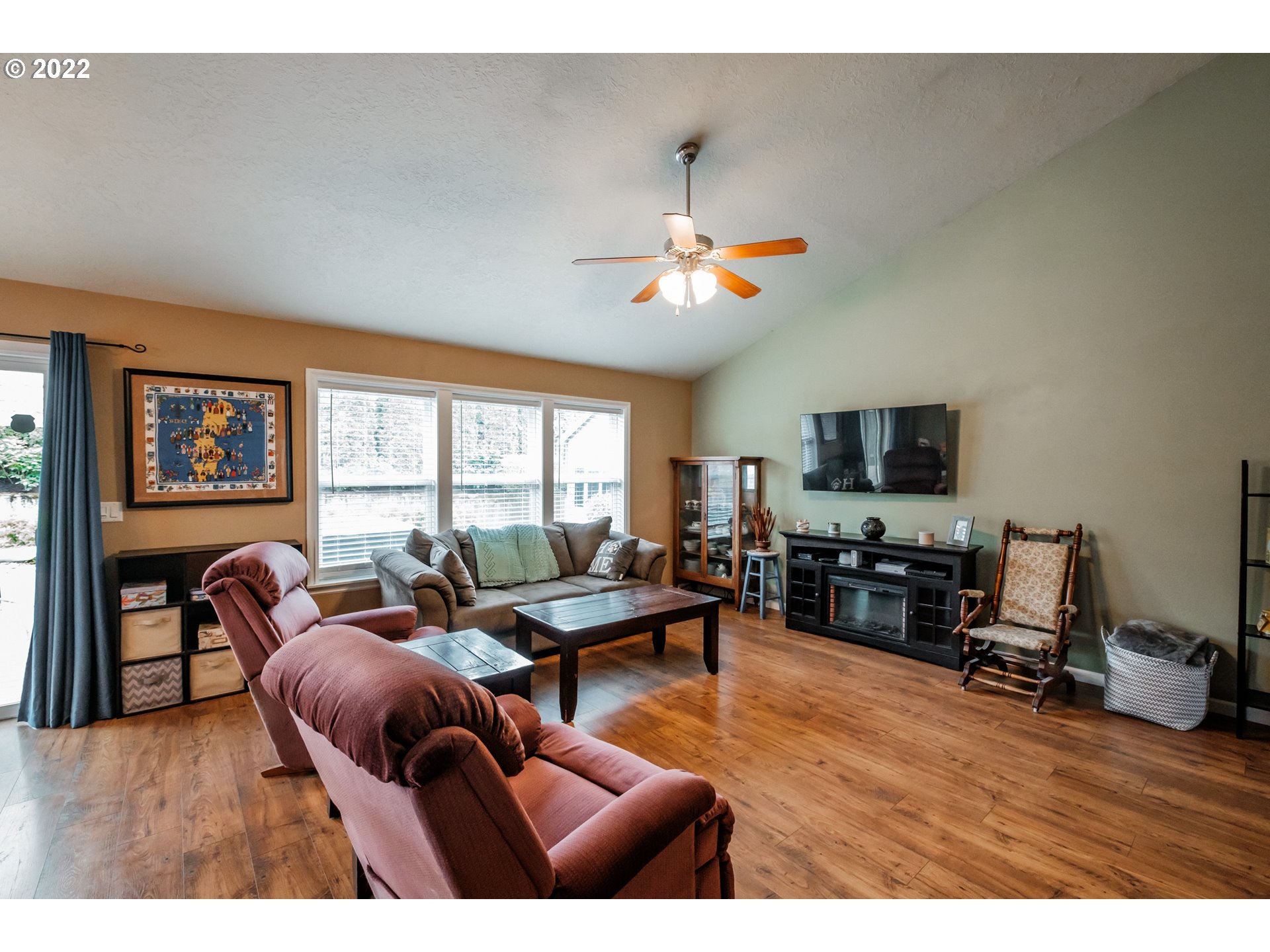 3778 10th Street Hubbard, OR 97032 - Photo 8 of 32 a living room with furniture a rug and a flat screen tv