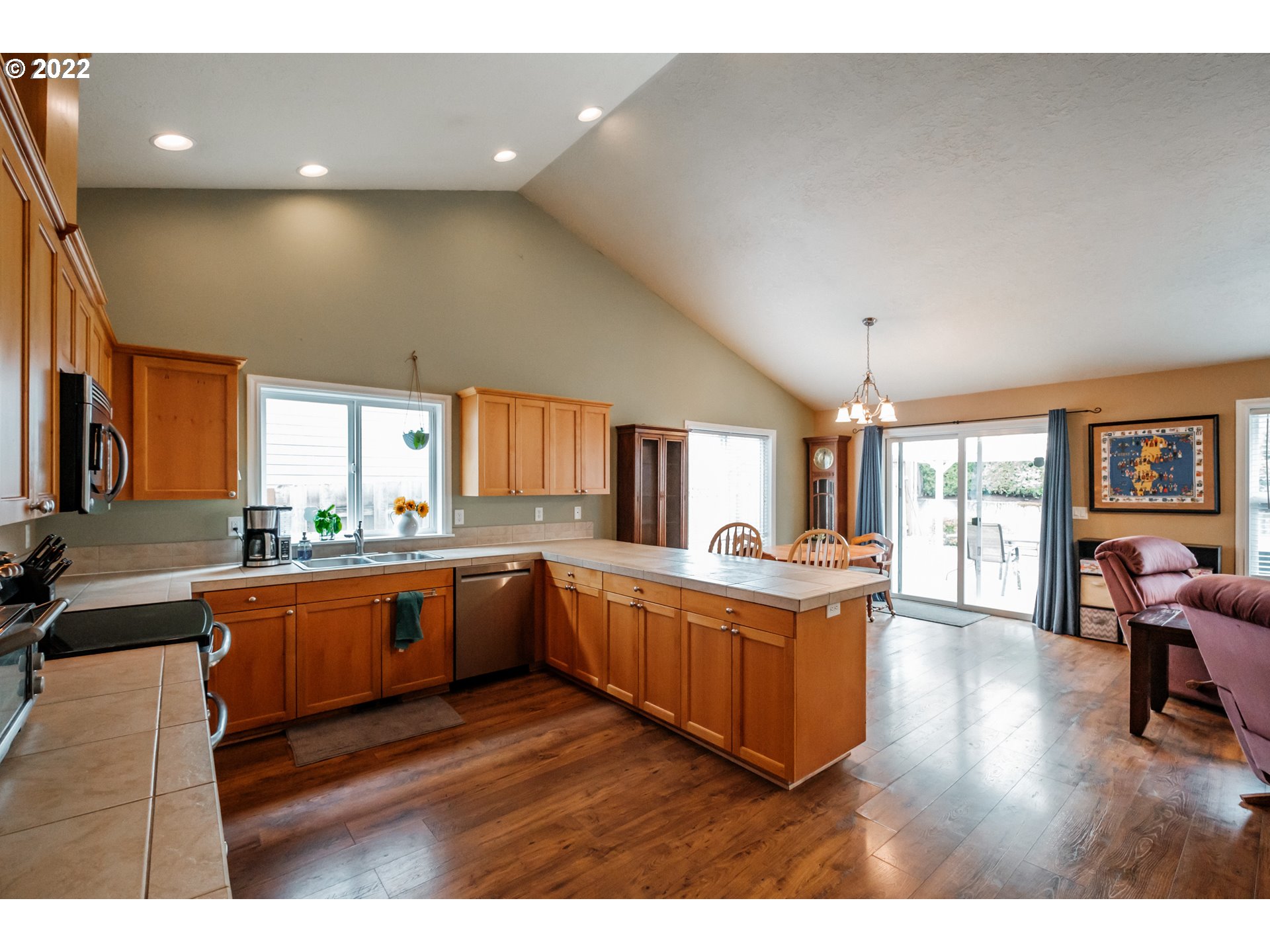 3778 10th Street Hubbard, OR 97032 - Photo 10 of 32 a kitchen with stainless steel appliances granite countertop a lot of cabinets and wooden floor