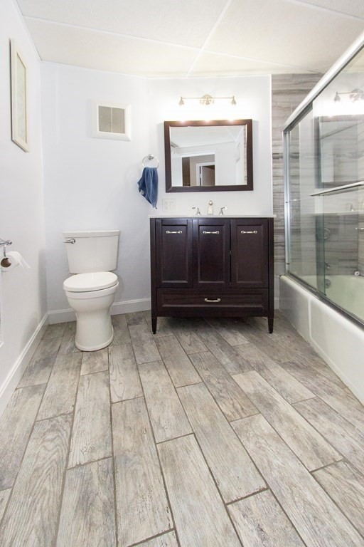 147 Turner Road, Unit 71 Holliston, MA 01746 - Photo 8 of 13 a bathroom with a sink a toilet and mirror
