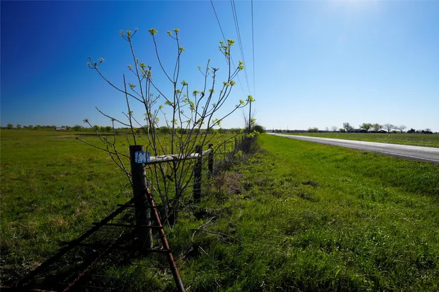 a view of a field with an ocean view