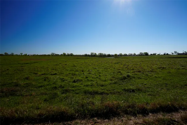 a view of a large body of water with a house in the background