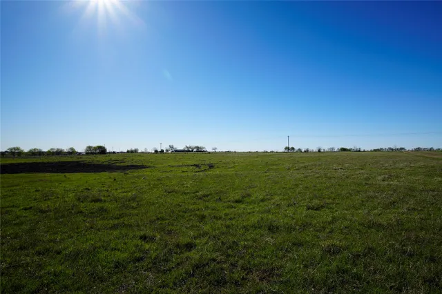 a view of a lake and green valley