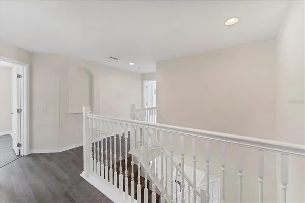 a large bedroom with a bed and a flat screen tv