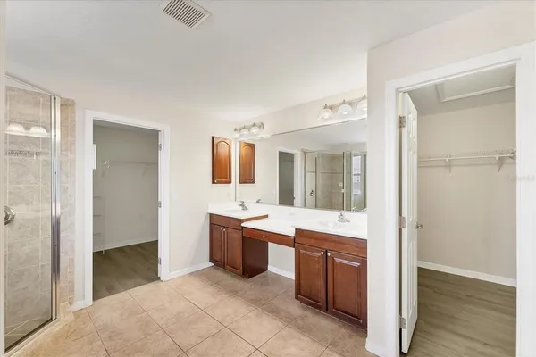 an empty room with a window and a ceiling fan