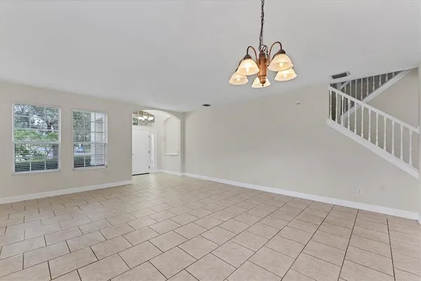 a living room with furniture a dining table and a window