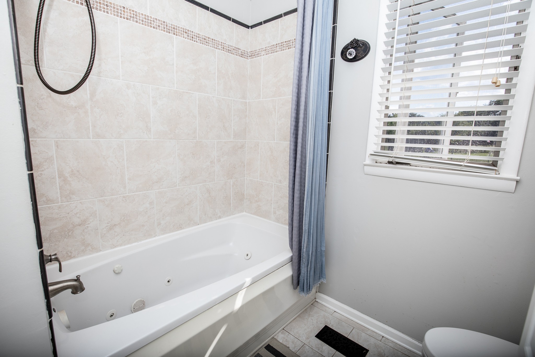 385 Lee Road Cottontown, TN 37048 - Photo 23 of 34 a bathroom with a bathtub and a shower