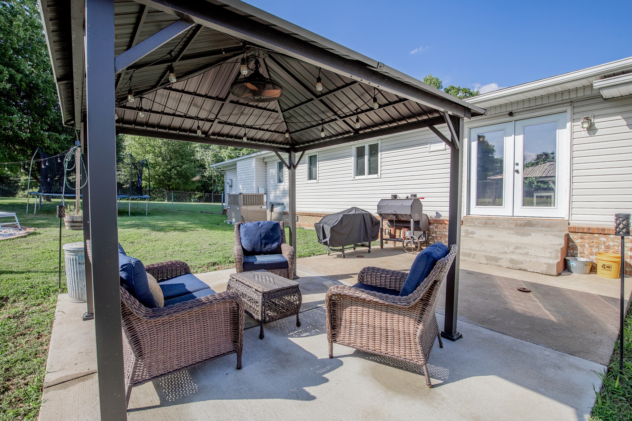 385 Lee Road Cottontown, TN 37048 - Photo 31 of 34 a view of a patio with couches chairs and a big yard