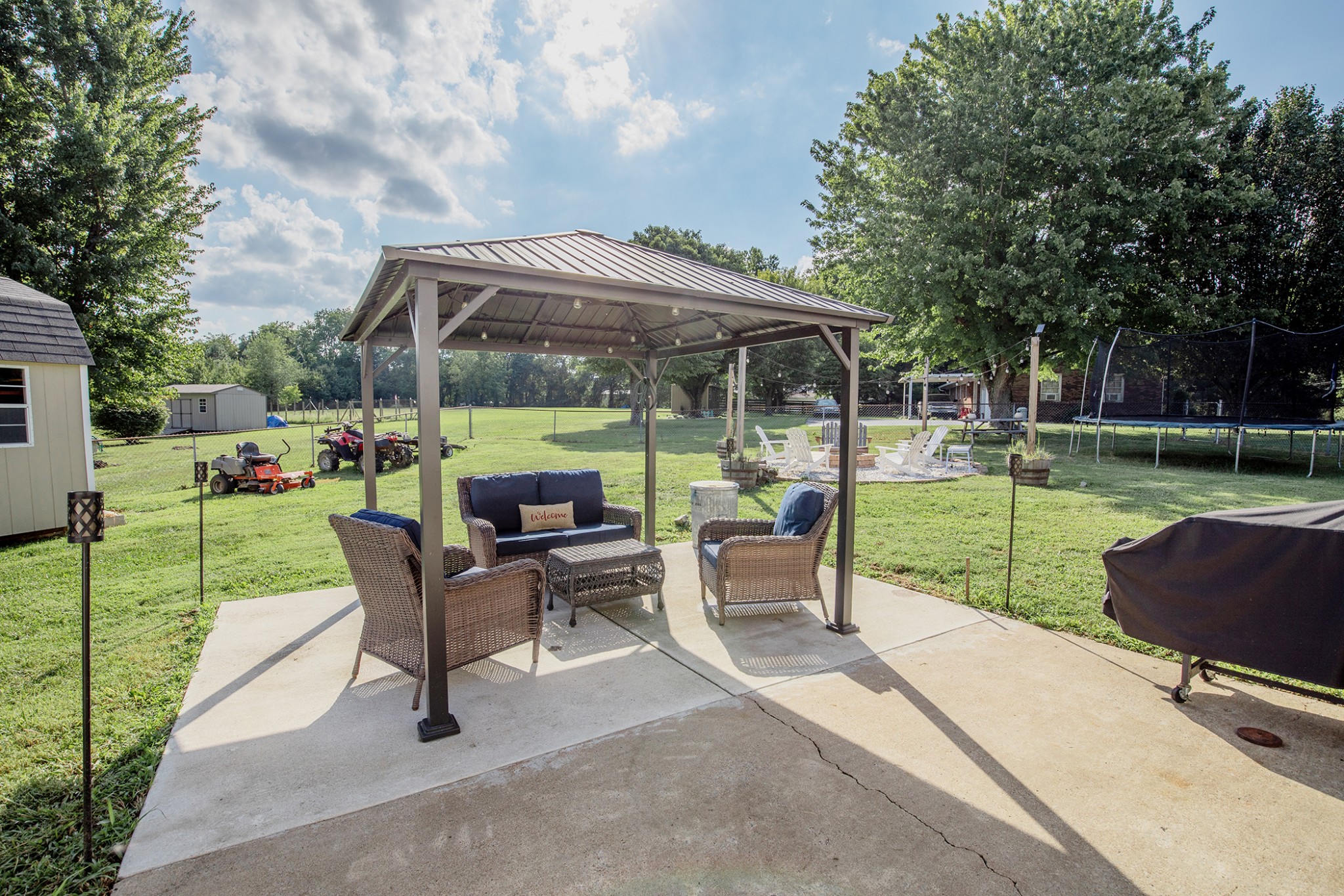 385 Lee Road Cottontown, TN 37048 - Photo 32 of 34 a view of patio with table and chairs under an umbrella