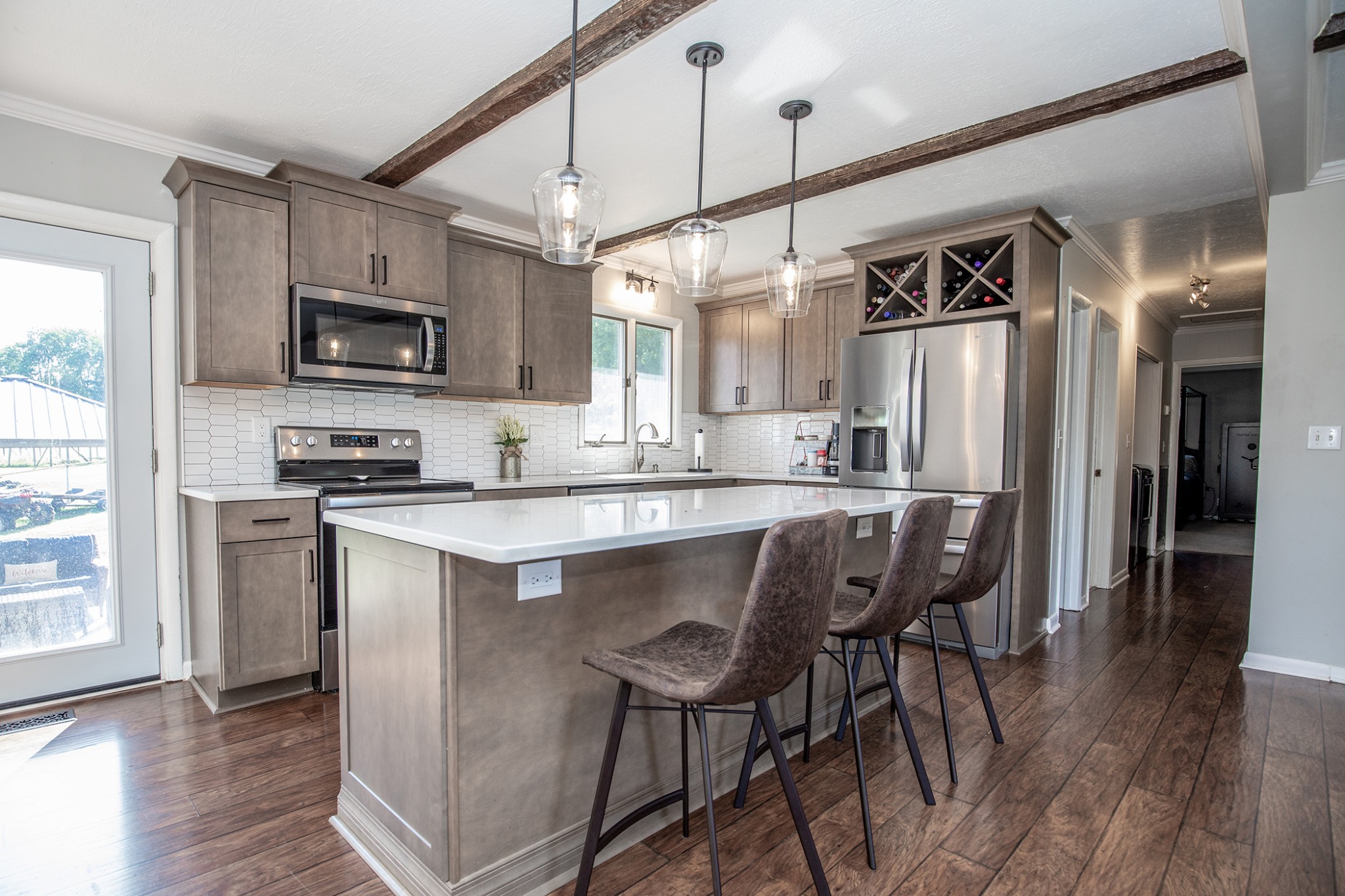385 Lee Road Cottontown, TN 37048 - Photo 10 of 34 a kitchen with stainless steel appliances granite countertop a microwave a stove a sink dishwasher and a refrigerator with wooden floor